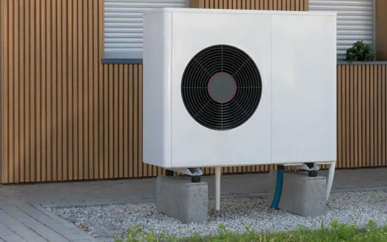 A ground air source heat pump outside of a building. 