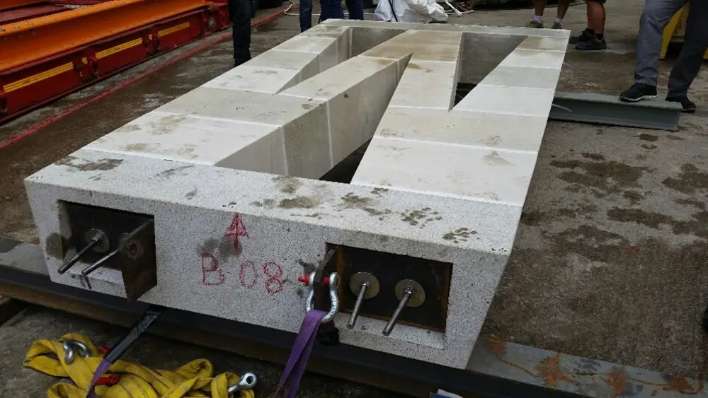 A prototype column for the Sagrada Familia, laying flat on two rods on the floor.