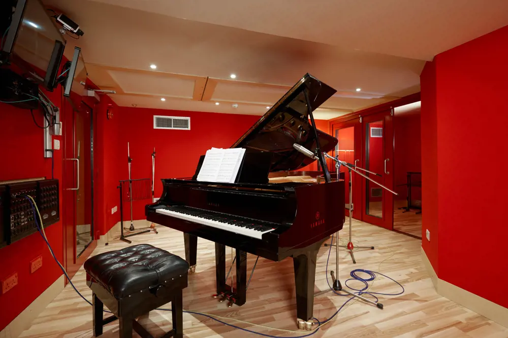 A classical piano in a recording room at Abbey Road Studios.