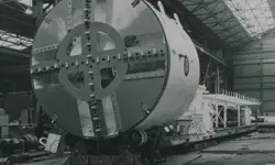 A grayscale image of the front of the prototype bentonite tunnelling machine in a factory.