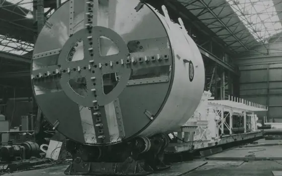 A grayscale image of the front of the prototype bentonite tunnelling machine in a factory.