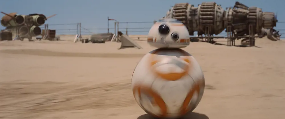 BB-8 moving in a desert landscape on the star wars set. 