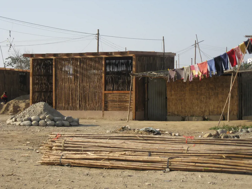 A building in Peru made out of thin flexible wood and a clothes line.