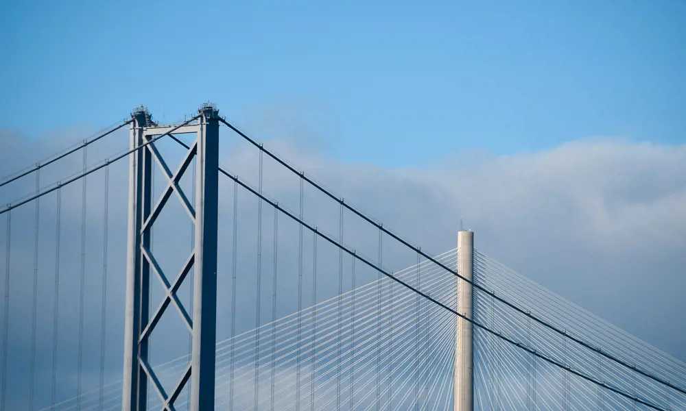 A photograph showing the towers of the Forth Bridge and Queensferry Crossing.