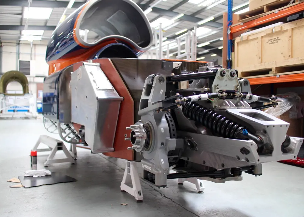 The steering suspension attached to the body of the bloodhound in a factory.