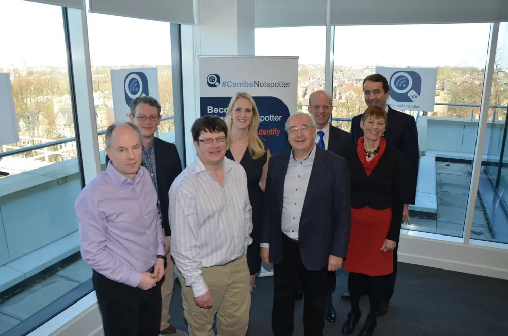 David Cleevely standing with a group of people smiling at the camera. 