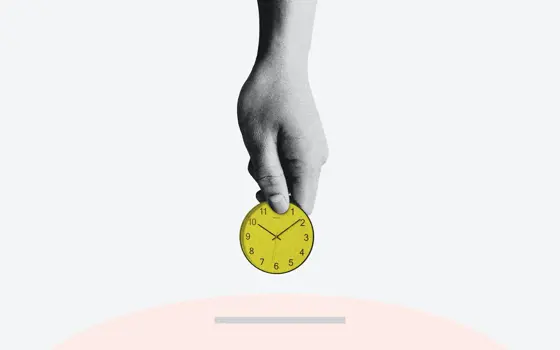 To represent the importance of time to the economy, a hand holding a coin with a clock face is moving to insert it into a slot.