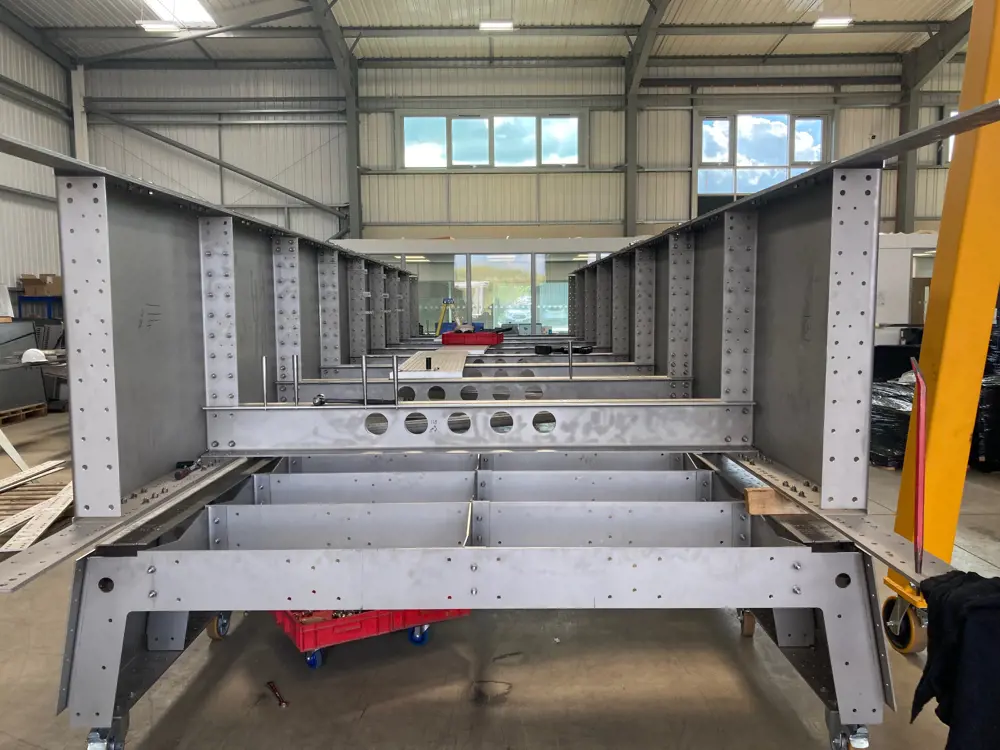 The flat pack footbridge being assembled in a warehouse.