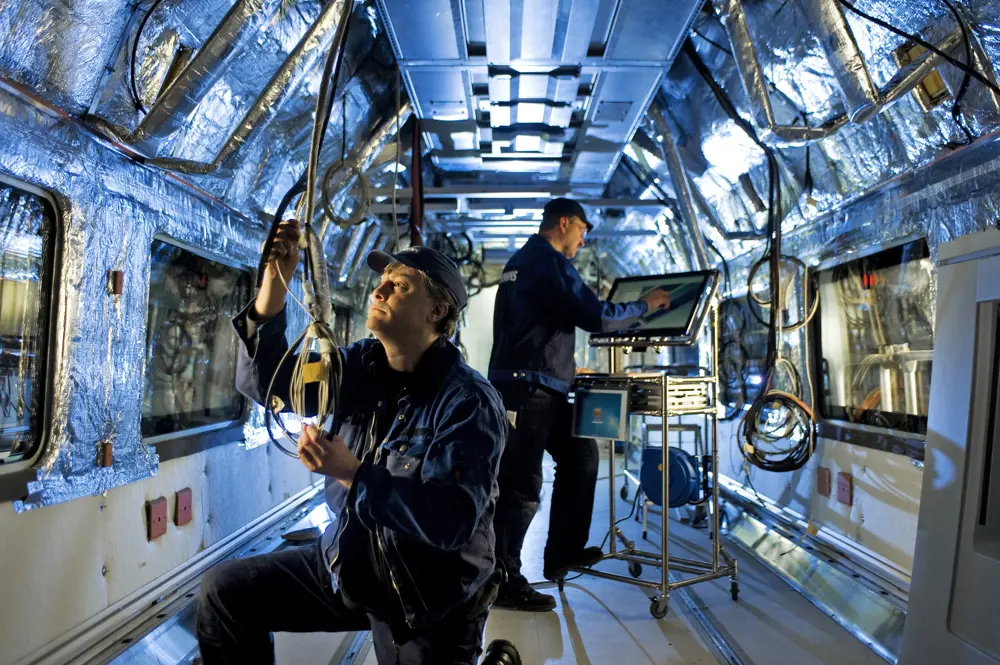 Engineers inside the Velaro, testing equipment.