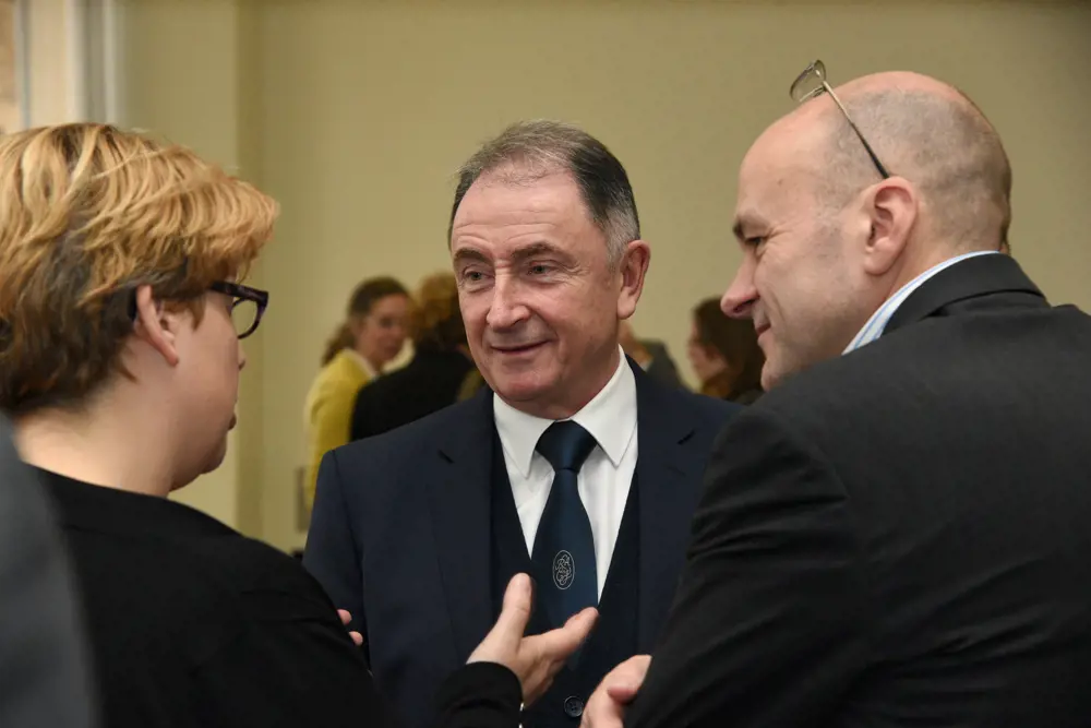 Sir Jim talking to two people at the Royal Academy of Engineering.