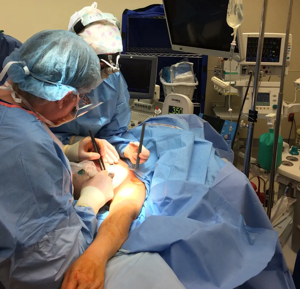 A surgeon operating on a patient. 
