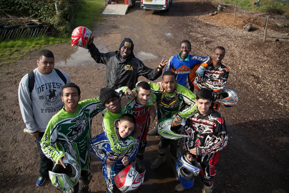 A group of young people wearing protective motorcycle suits. 