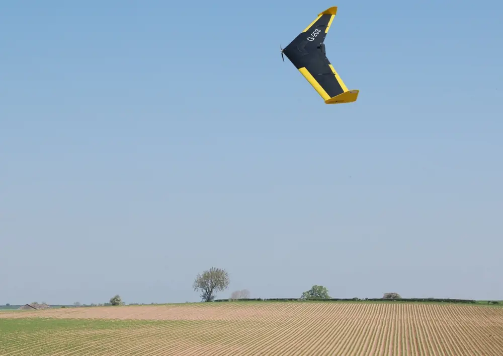 A drone flying over a field. 
